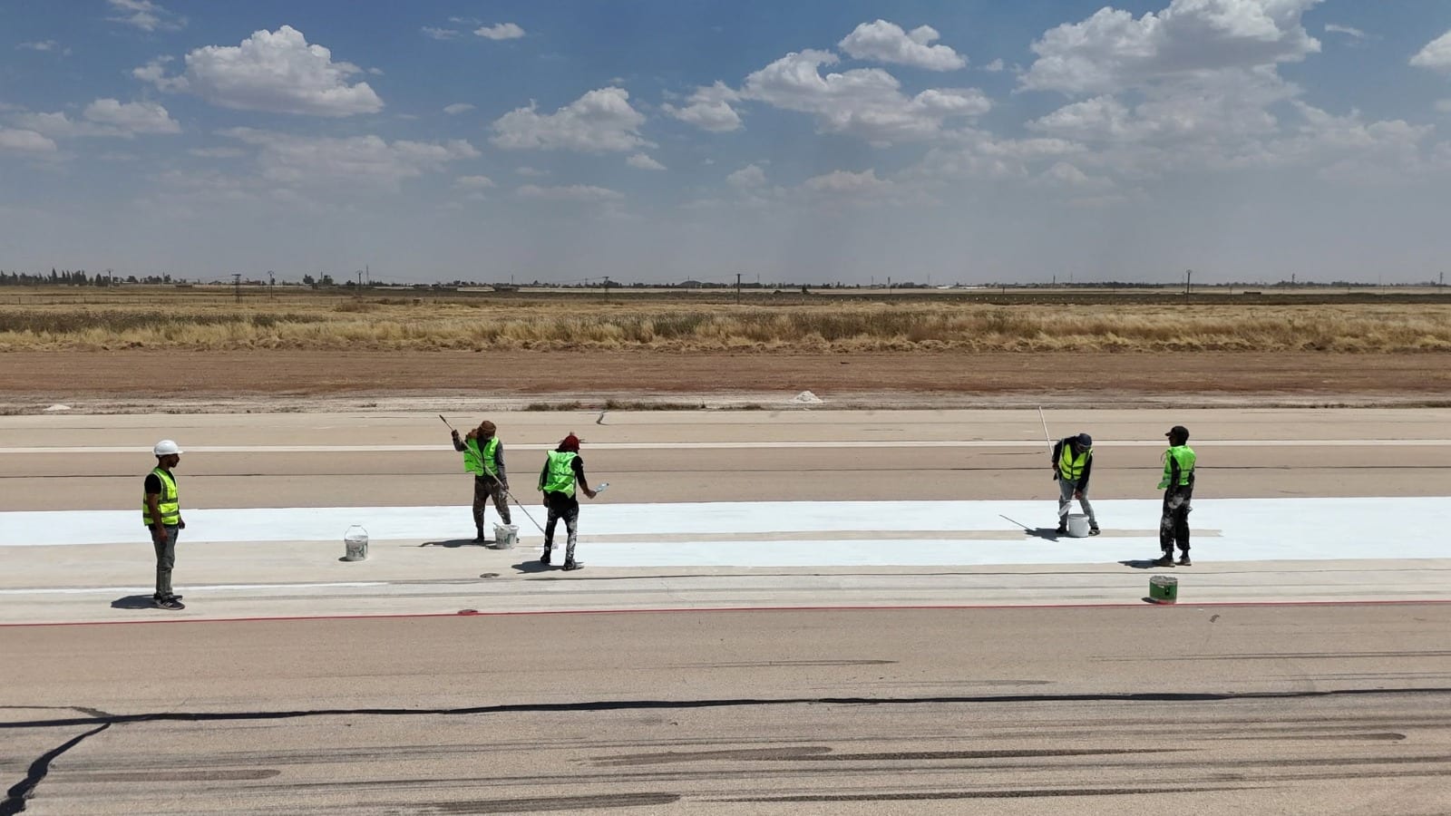 Airfield marking team on an active runway